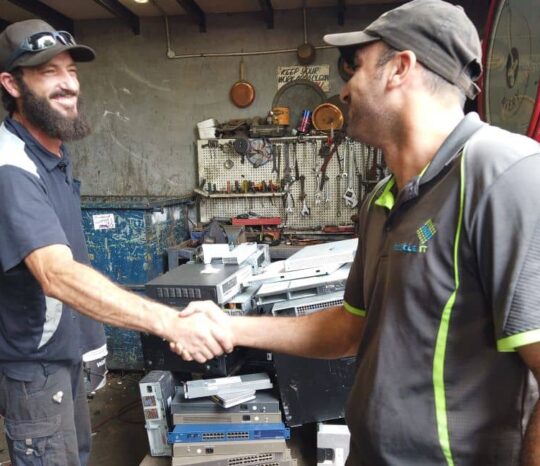 Collins Recycling staff members shaking hands.