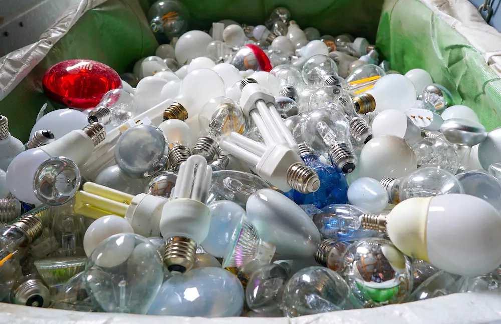 Recycling bin full of various types of light bulbs